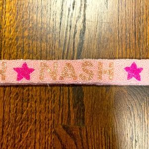 ‘NASH’ bag strap.